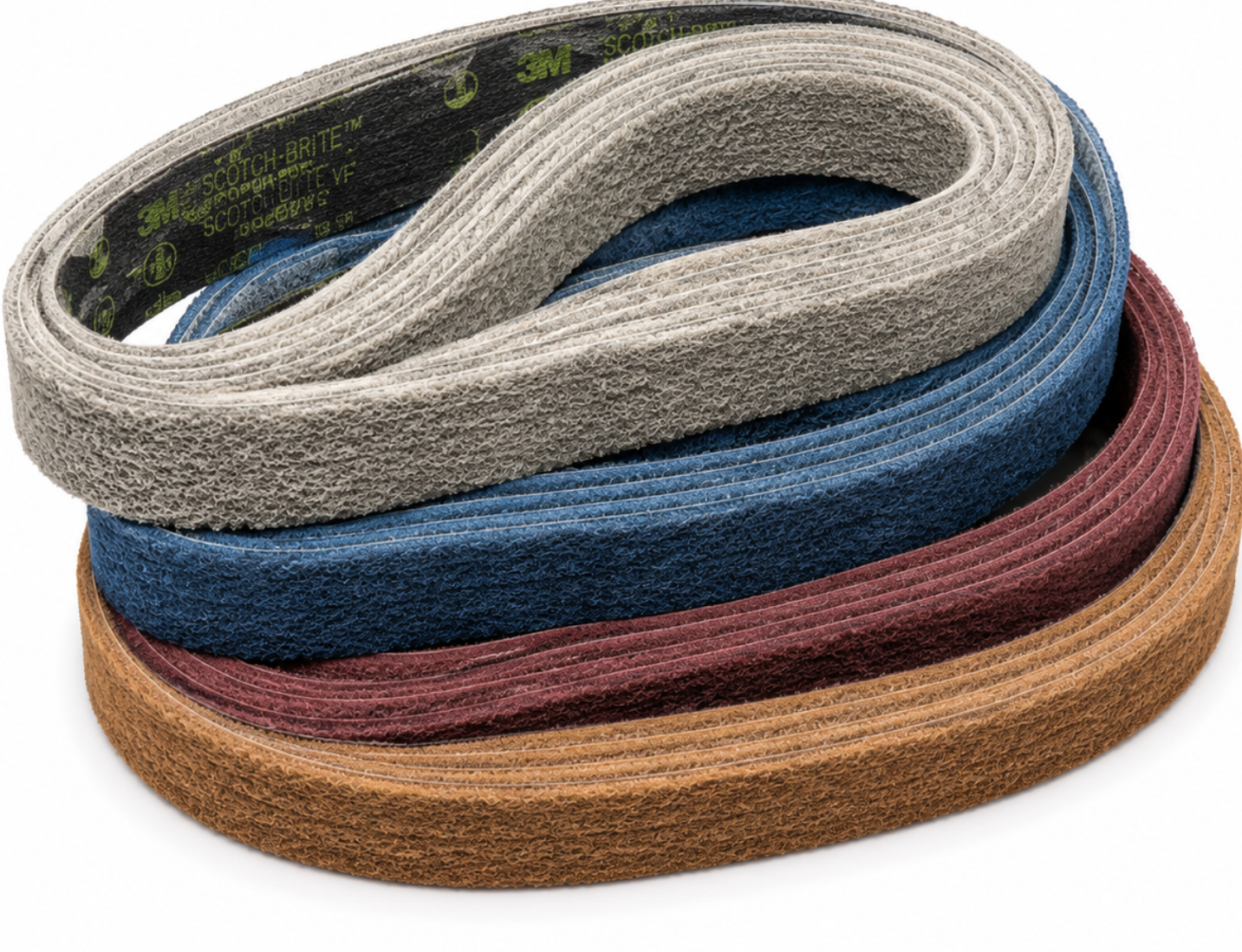 Three coiled abrasive belts in gray, blue, and brown, stacked on a white background. The gray belt is on top, showing the green '3M' brand logo printed on its inner side.